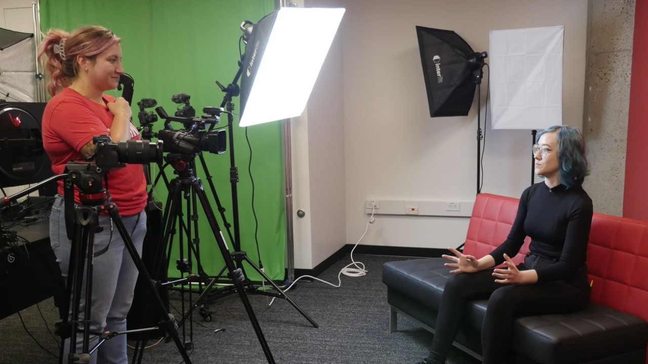 UC students Fiona Harrell-Duchaine (seated) utilizes the broadcasting studio with a member of Cincinnati Fear.