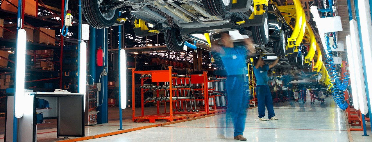 Factory manufacturing workers working in assembly line.