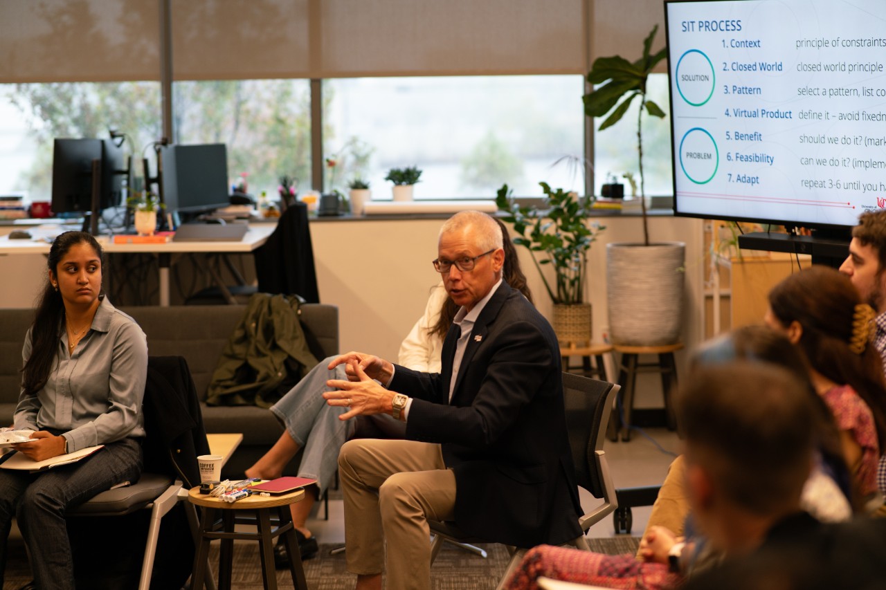 Arthur Pancioli, MD, chair of the UC Department of Emergency Medicine, speaks to a group of people sitting on chairs.