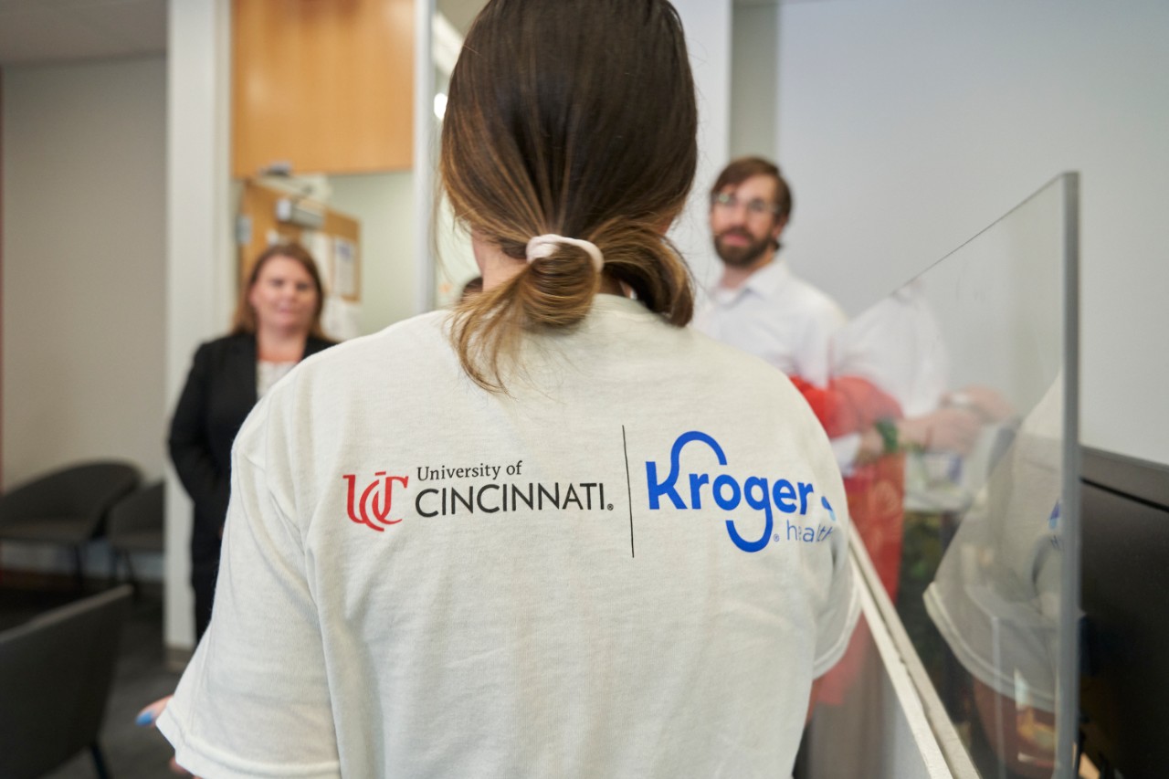 Student shirt shows UC and Kroger logos