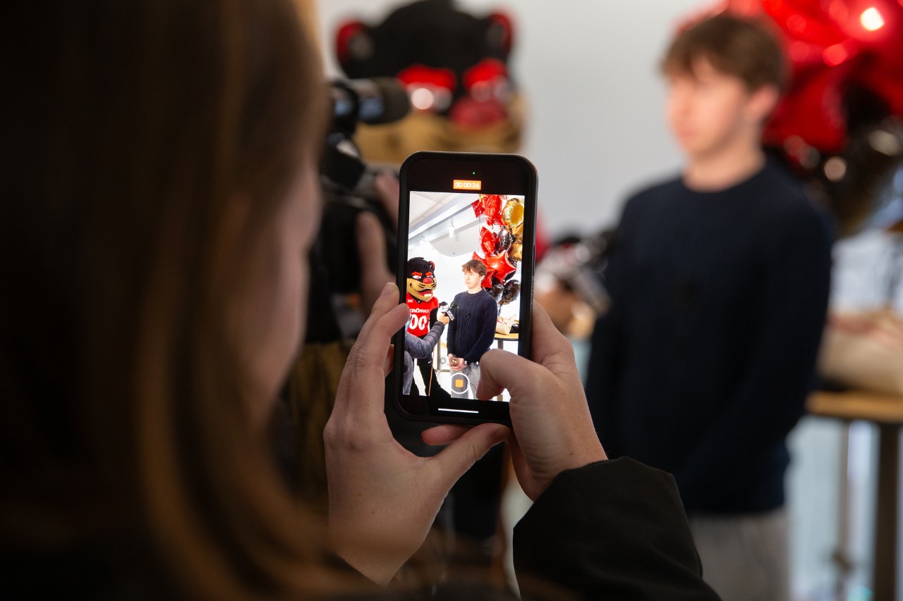 UC surprises twins Jude and Frances Eckerle at Highlands High School on Decision Day.