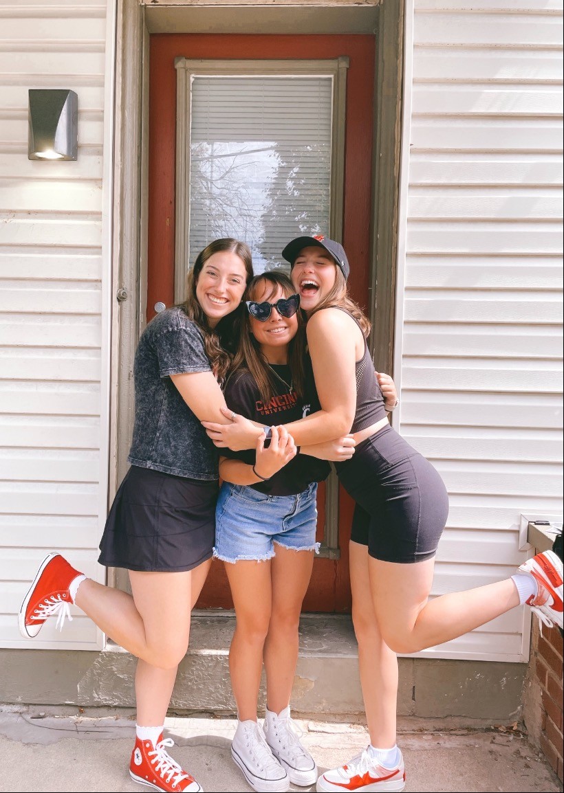 Greer hugging friends on campus