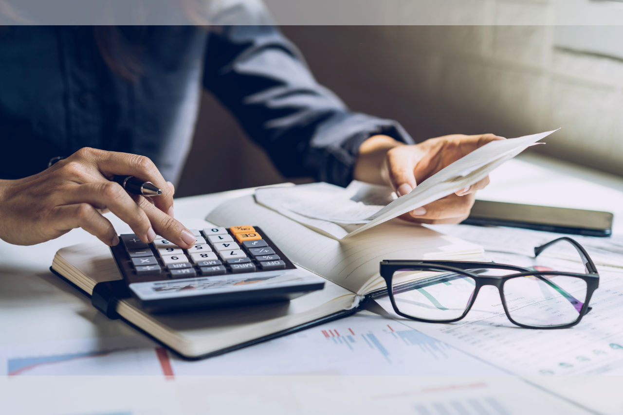 A business owner works on their taxes at their desk.