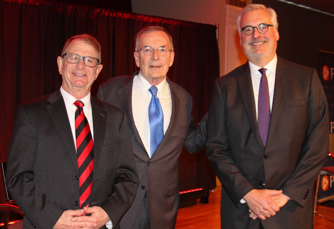 Stu Hoffman, Greg Valliere and Carl Goertemoeller stand in suits and ties.