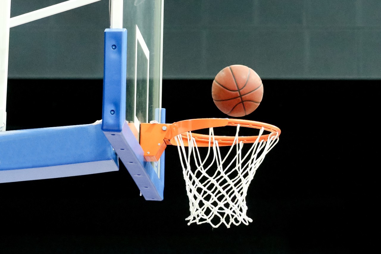 basketball post with a hoop and ball going into it