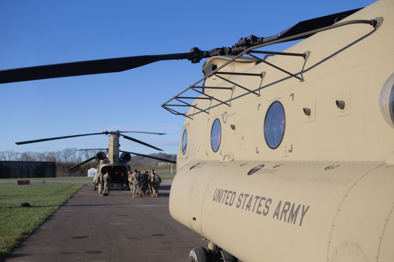 Two Chinook helicopters sit on a tarmac at Lunken Airport.