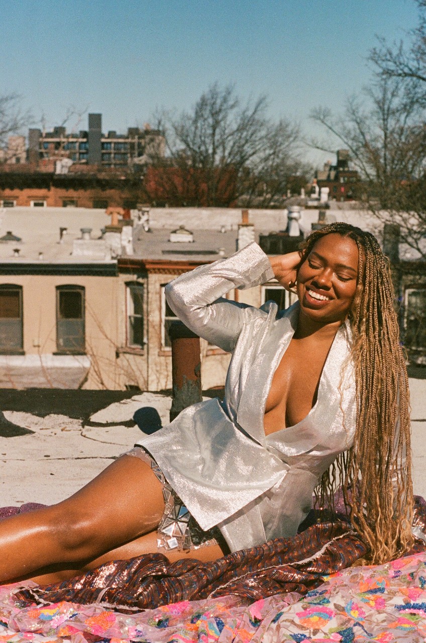 Asha Ama, in a silver dress on the roof of urban Cincinnati, photographed by Marek Urbanski.