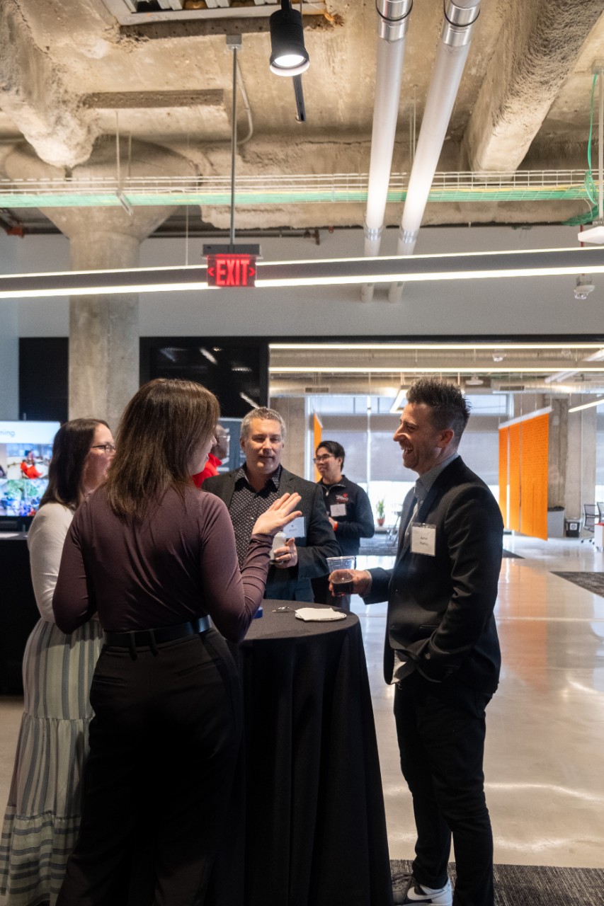Director of the NIS program, Aaron Bradley, mingles with corporate leaders and students prior to panelist discussions. Photo/
