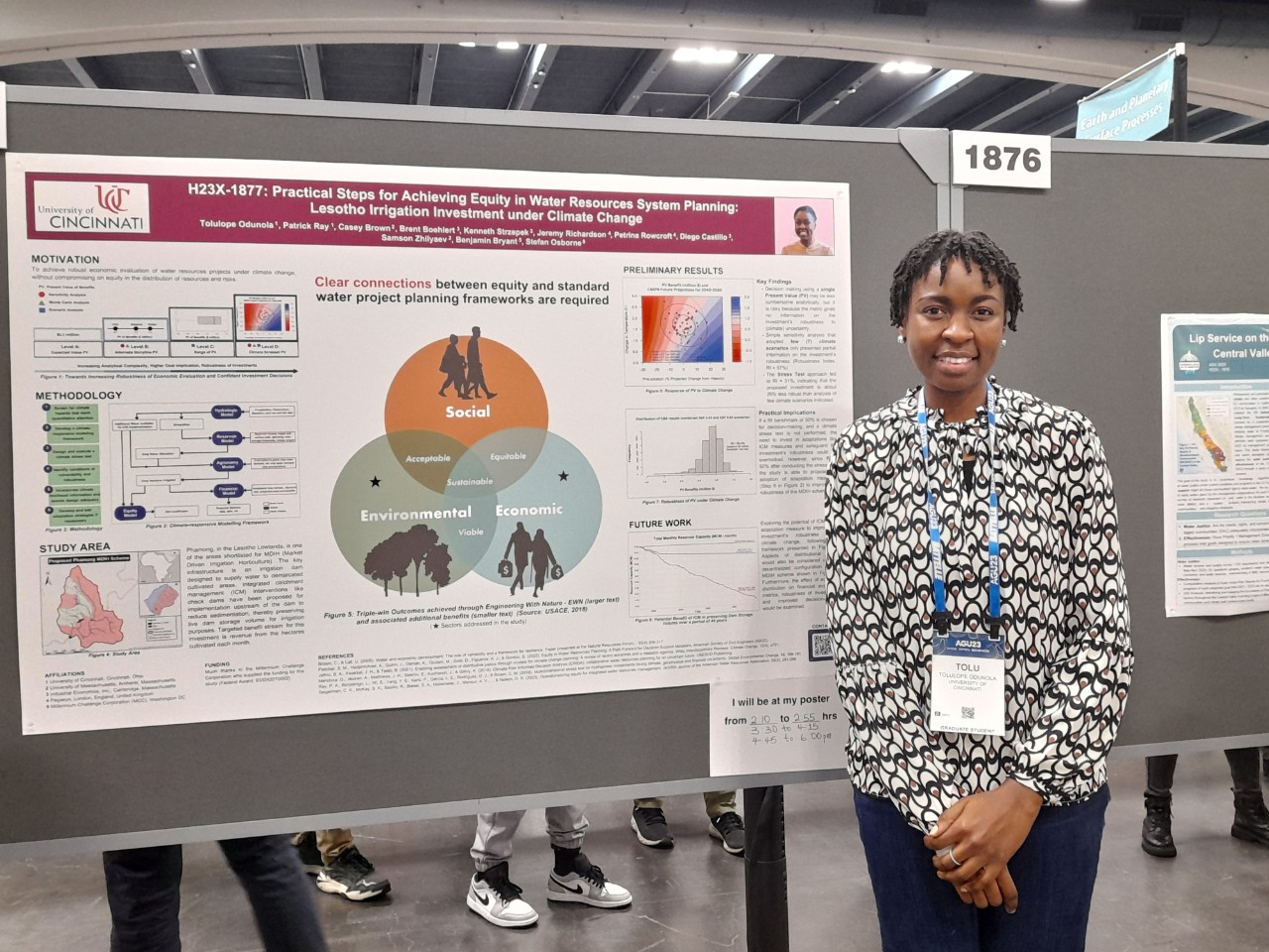Tolulope Odunola stands next to her poster at the AGU fall meeting. 
