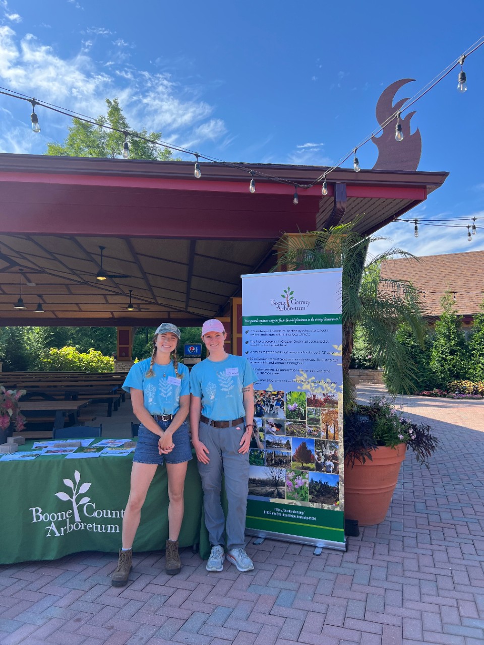 Sophia Becker (left), UC Horticulture alumna '23 serving as the Arboretum Apprentice and vendor representative of Boone County Arboretum (BCA) with current UC Horticulture student and BCA intern, Emily Herschelman (right) smiling for a photo at the HORT Career Day.