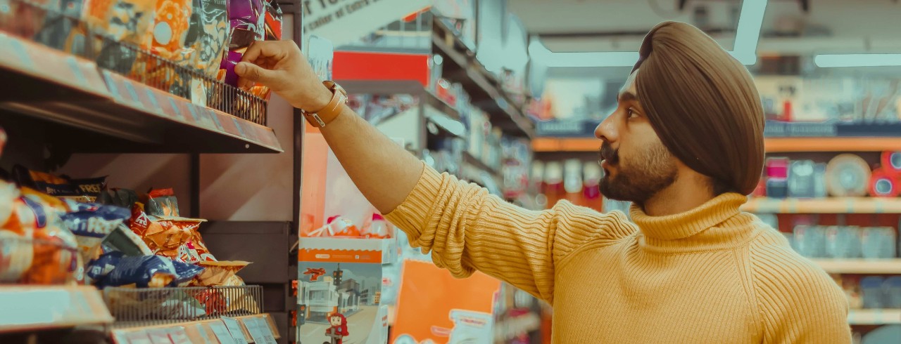 A man shops for snacks. 