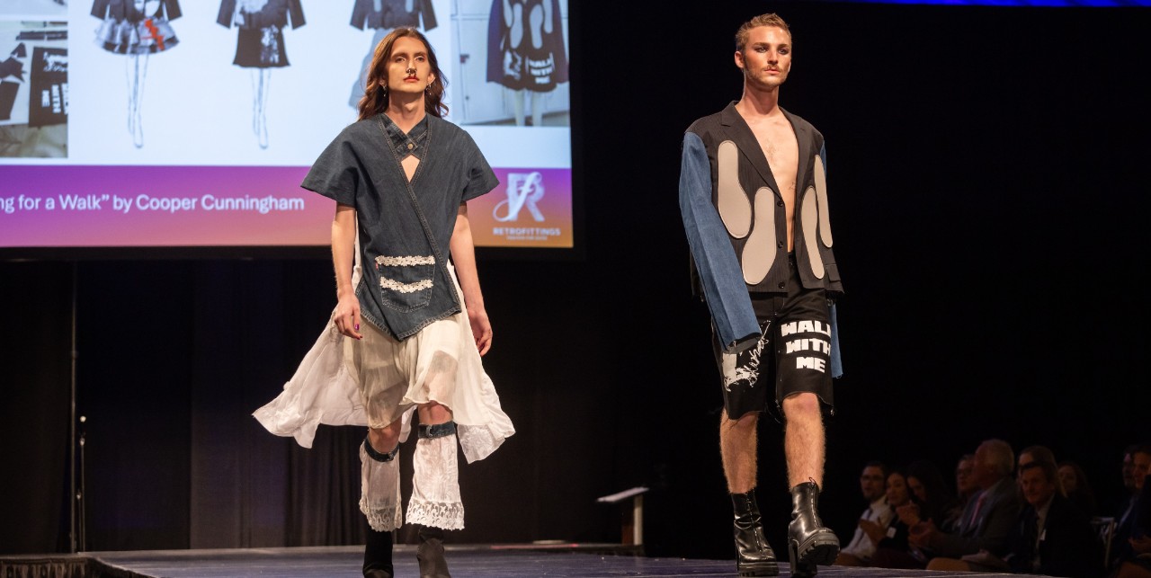 Two models on the runways modeling fashions made out of thrifted items 