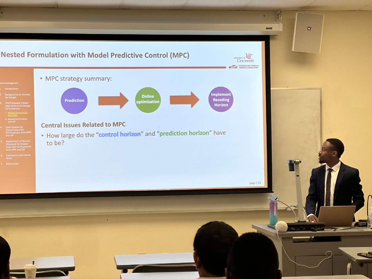 Oluwaseun Adekoya presenting to a room. He is a graduate student at UC.