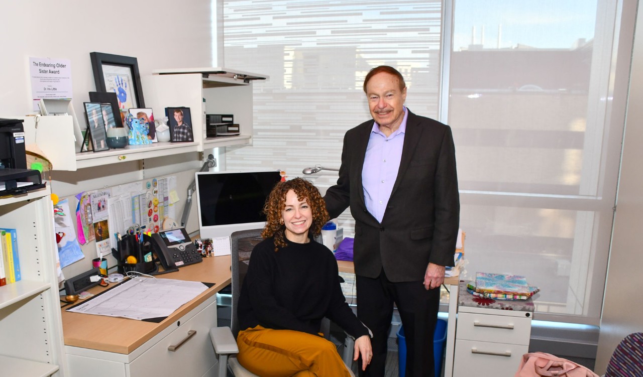 Iris Gutmark-Little and Ephraim Gutmark pose in her office.
