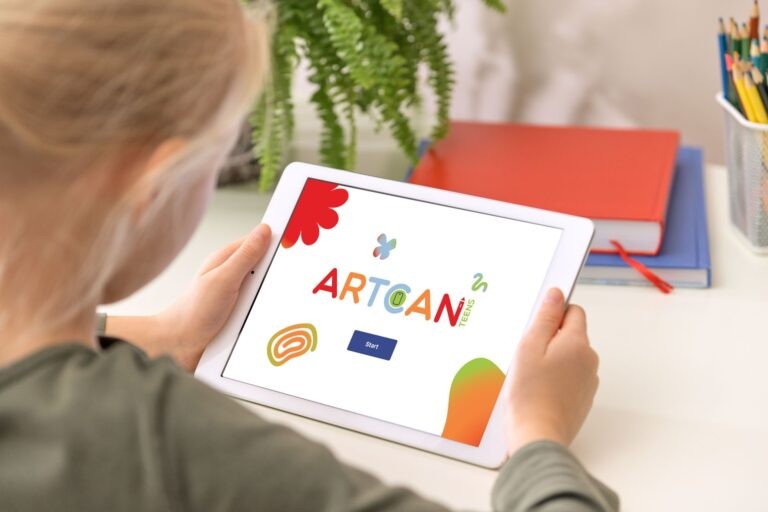 A young person holds a tablet with the ARTCAN application displayed