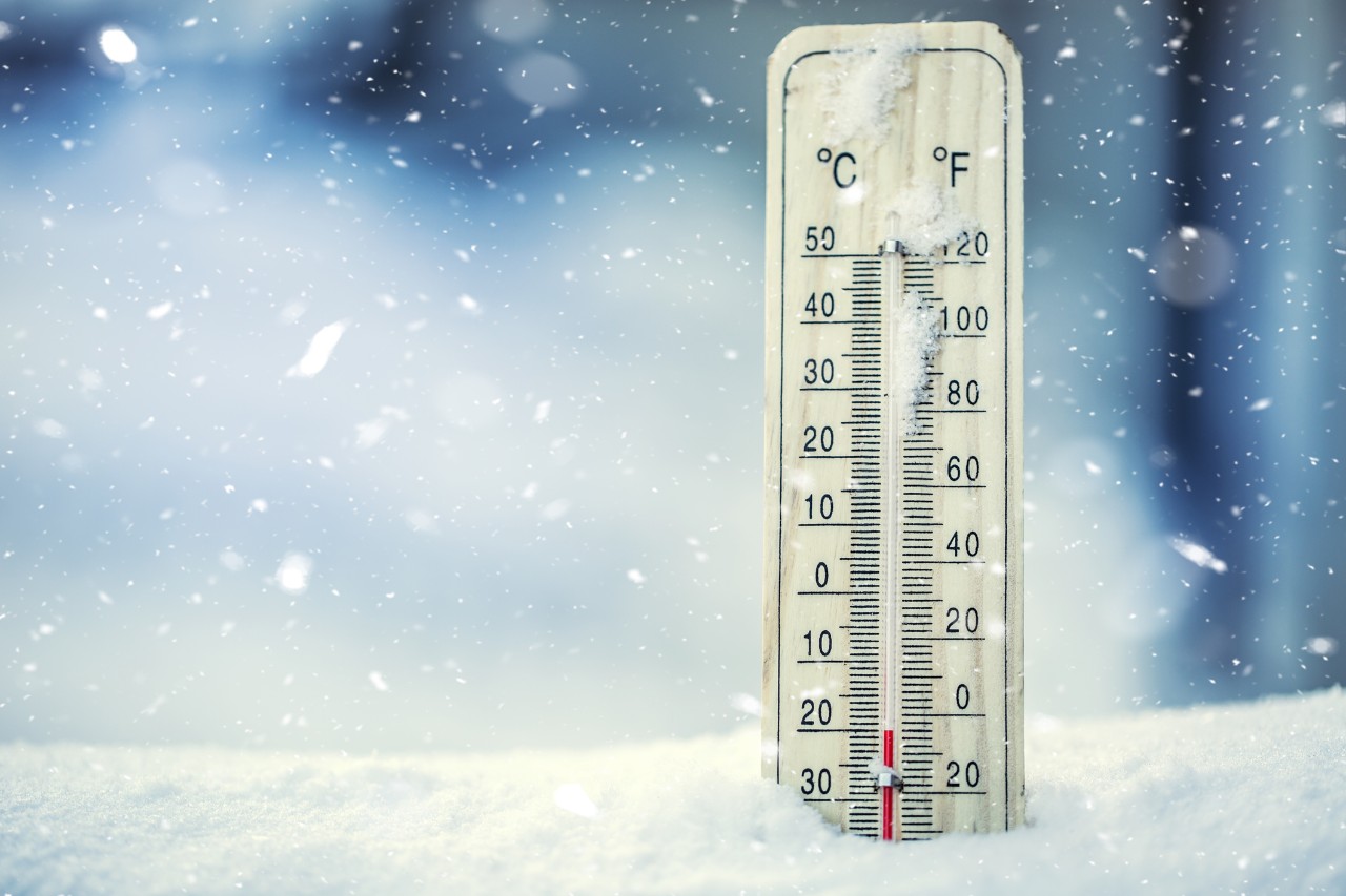 Illustration of thermometer displaying cold temps while positioned in snow