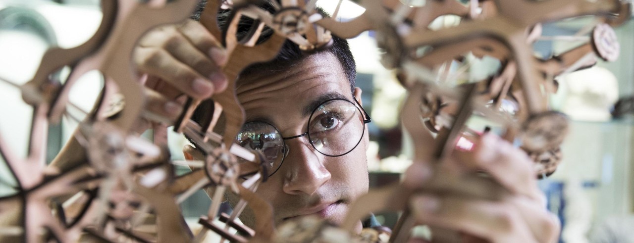 UC DAAP student takes a closer look at his 3D design. Photo/Lisa Ventre/UC Marketing + Brand. 