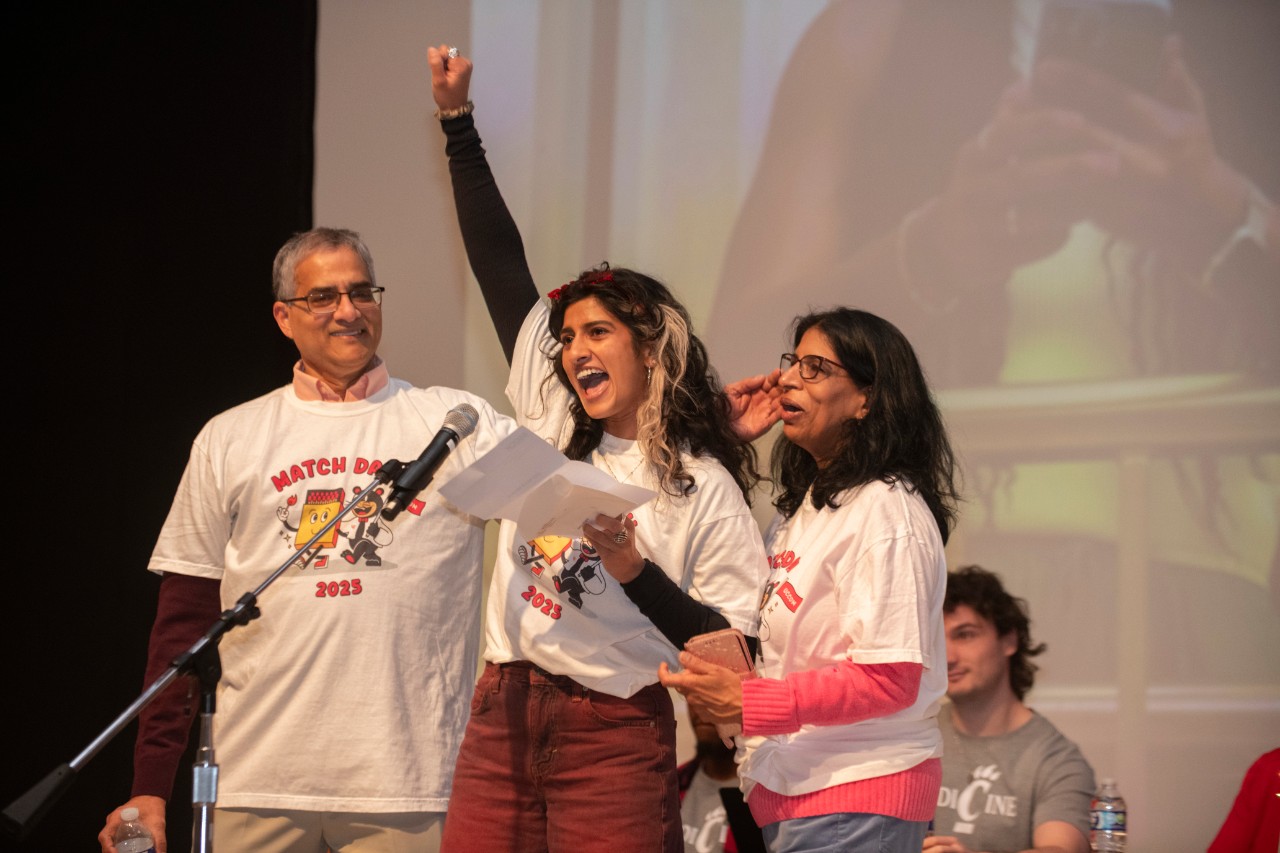 A medical student celebrates her match with her parents.