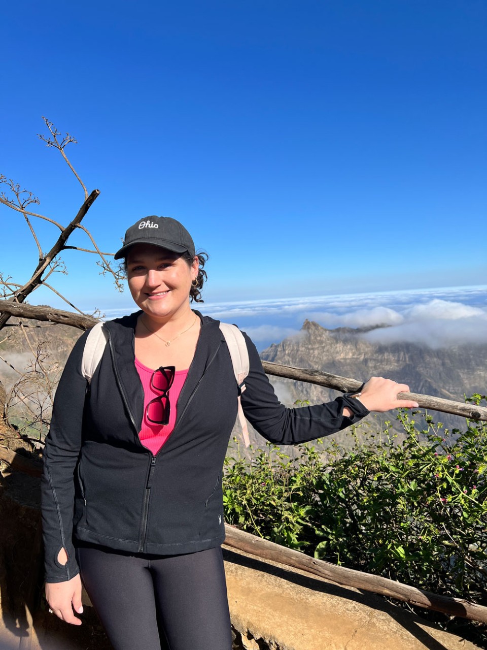 woman posing on mountaintop trail