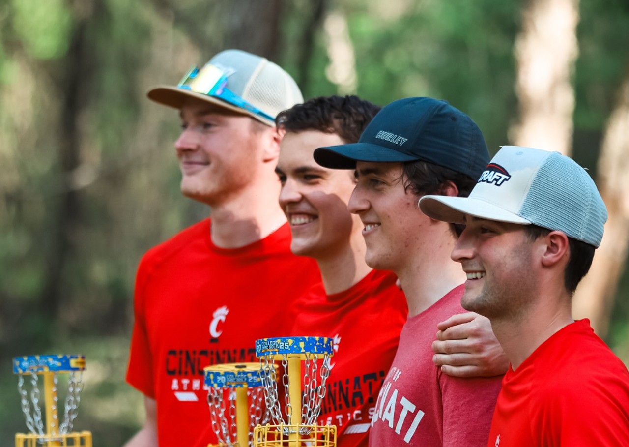 Members of the discats pose for a photo holding their basket-shaped trophies.