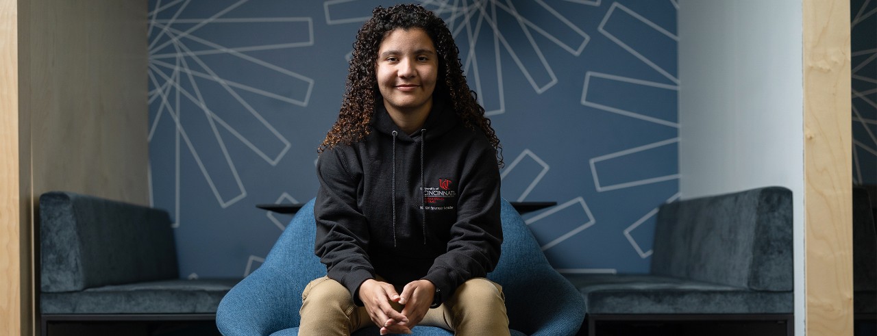 Katelyn Cotton shown seated in UC's Digital Futures building