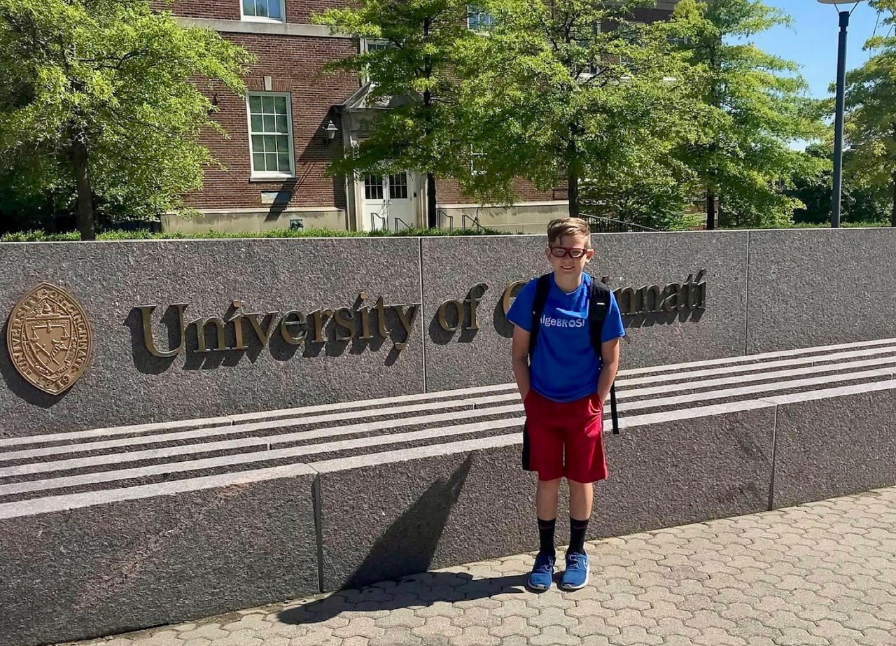 Caden Elrod poses in front of the University of Cincinnati fountain.