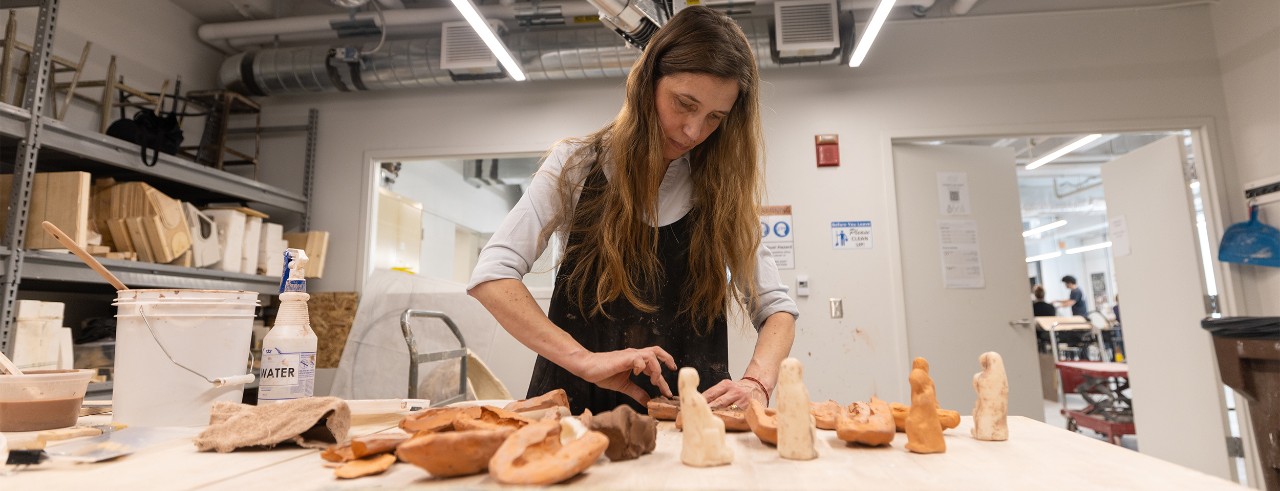 Florence Gaignerot-Driessen works with clay in a ceramics lab.