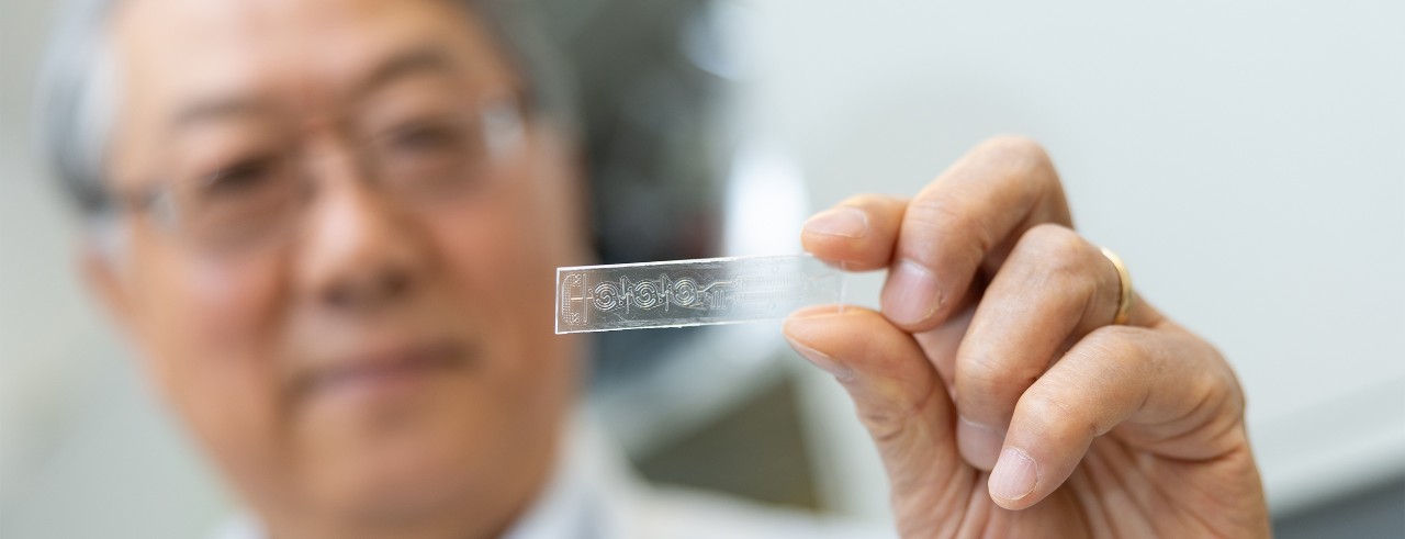 Chong Ahn holds up a testing strip.