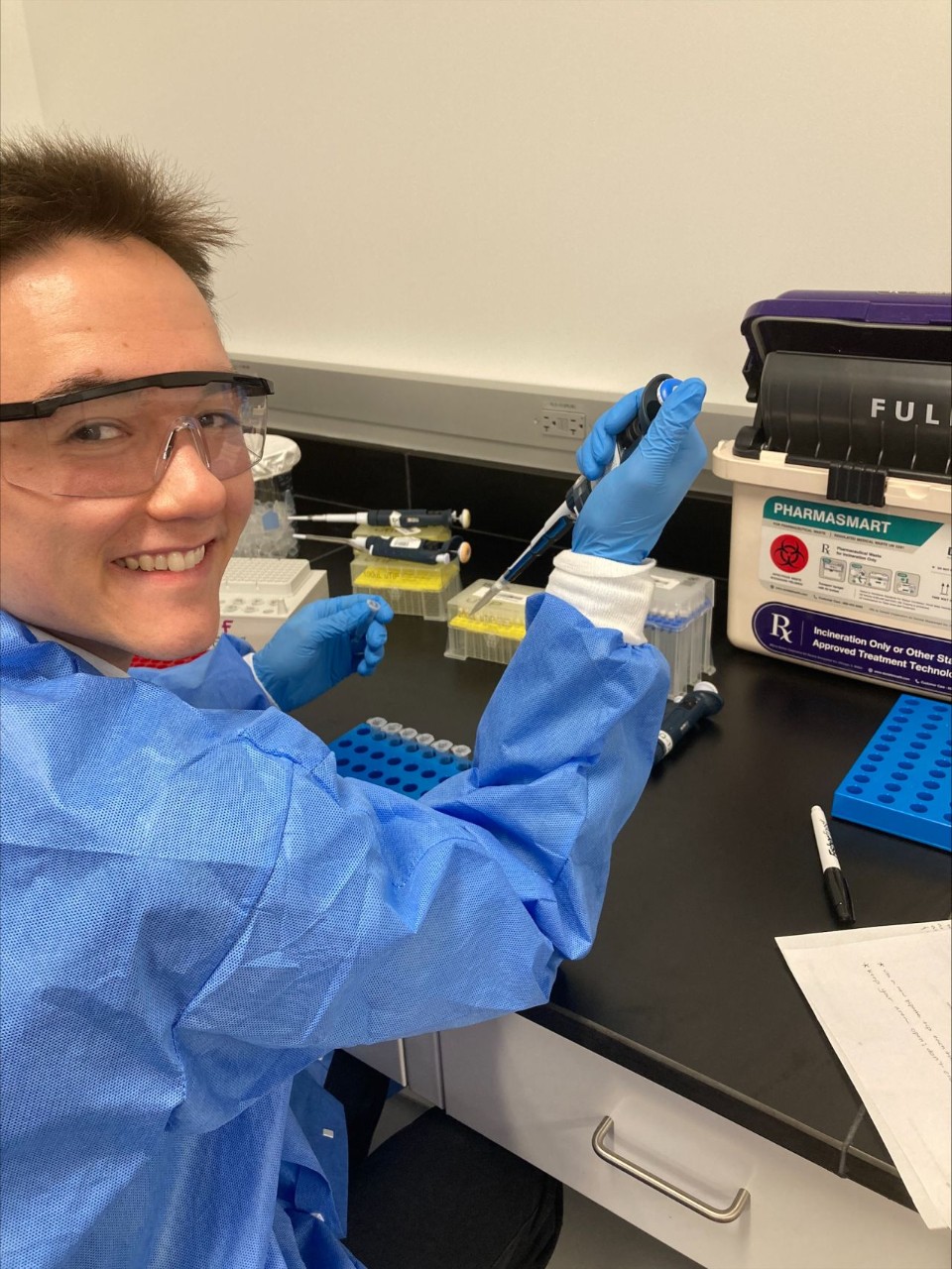 smiling student in lab gear