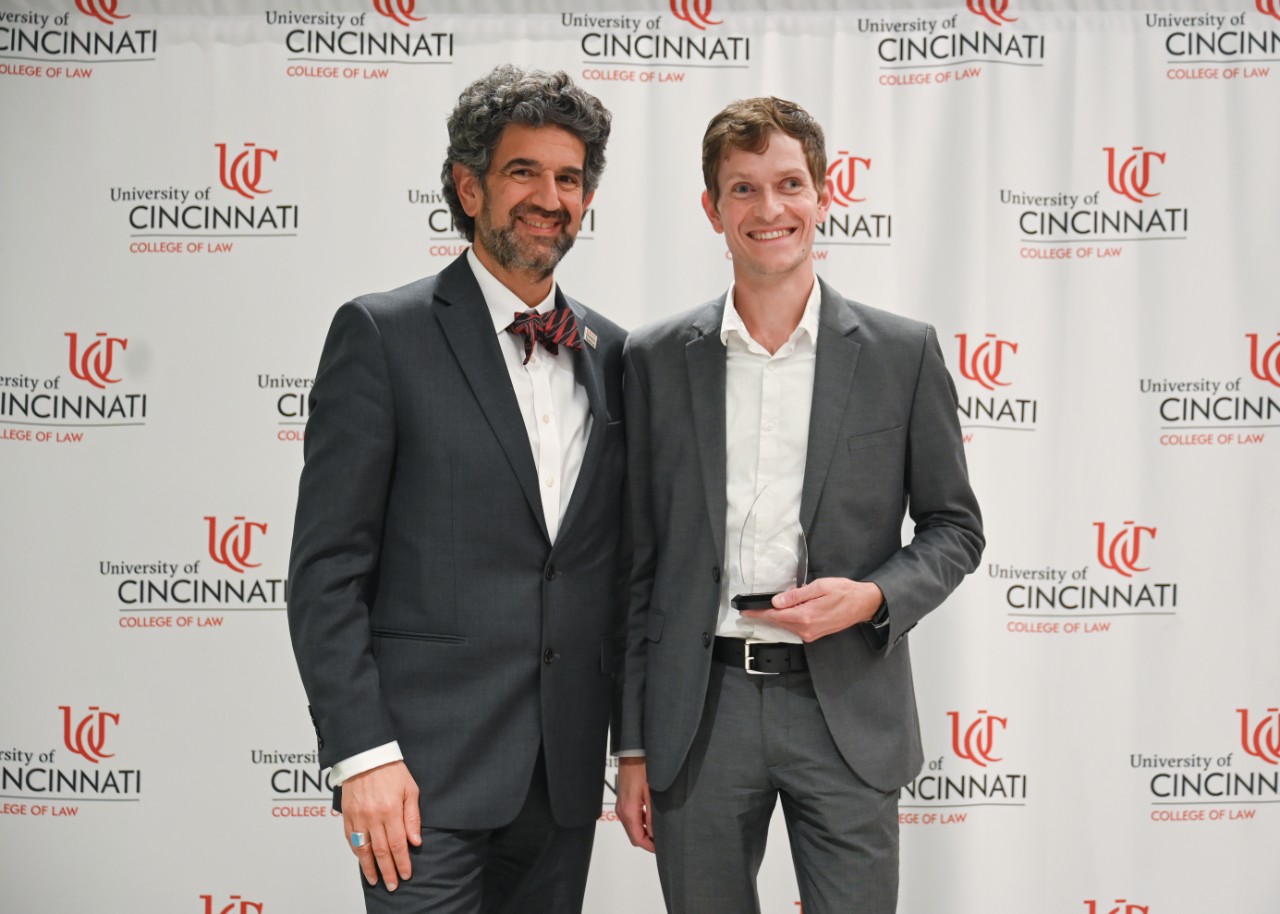 Dean Haider Hamoudi and Professor Ryan Thoreson with award