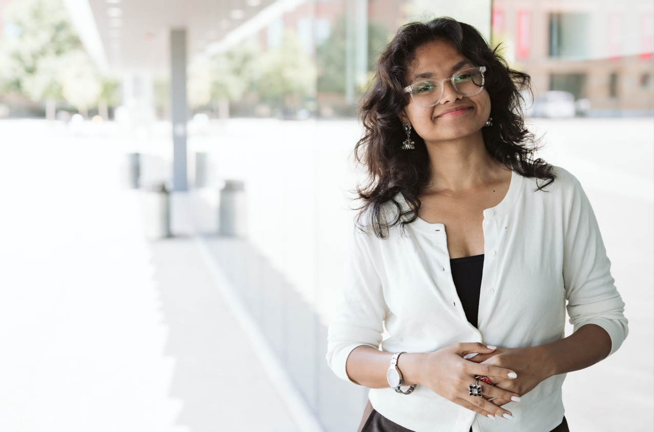 Sharvari Girish Patil wearing a white sweater outside.