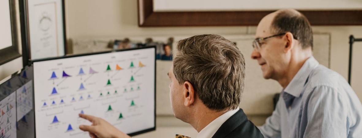 Strawn and Mills examine data on a computer together.