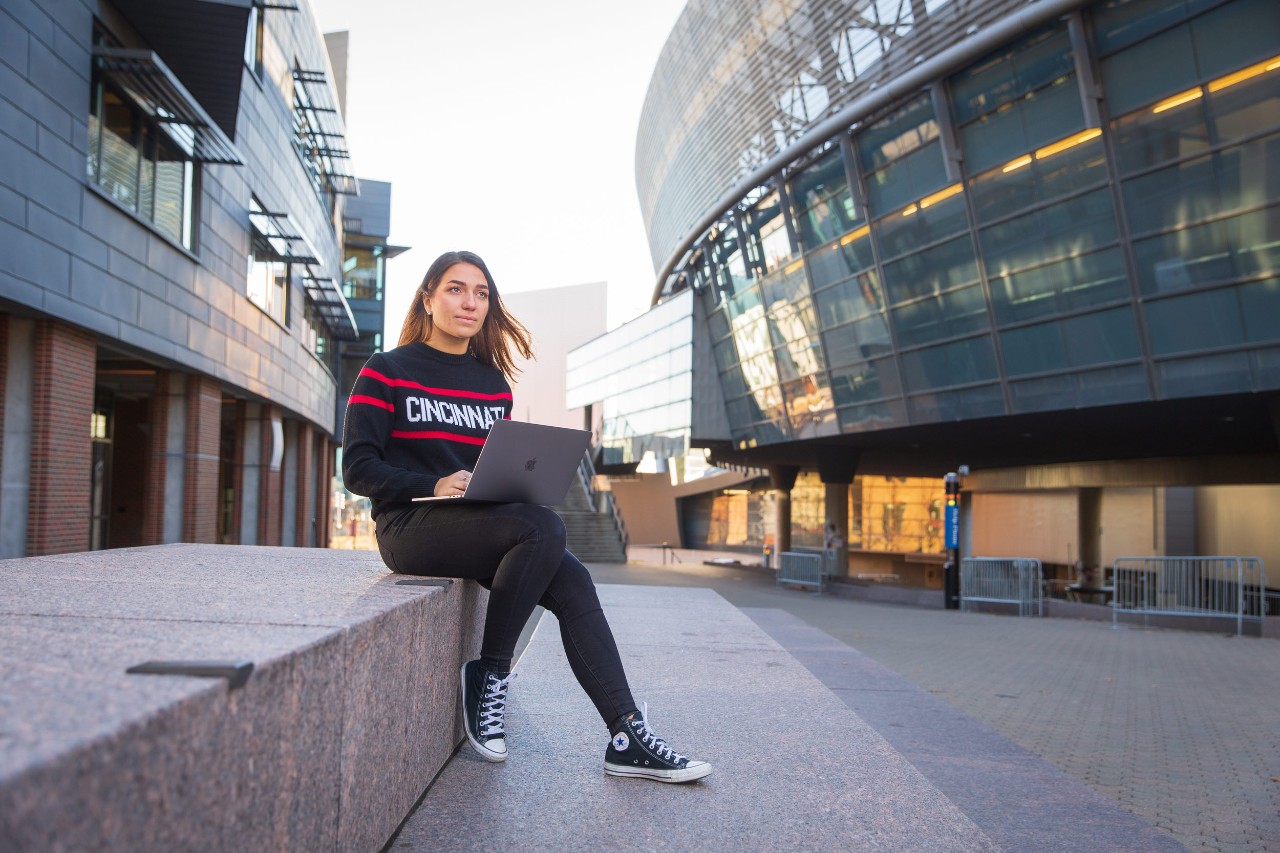 Three UC students conversing