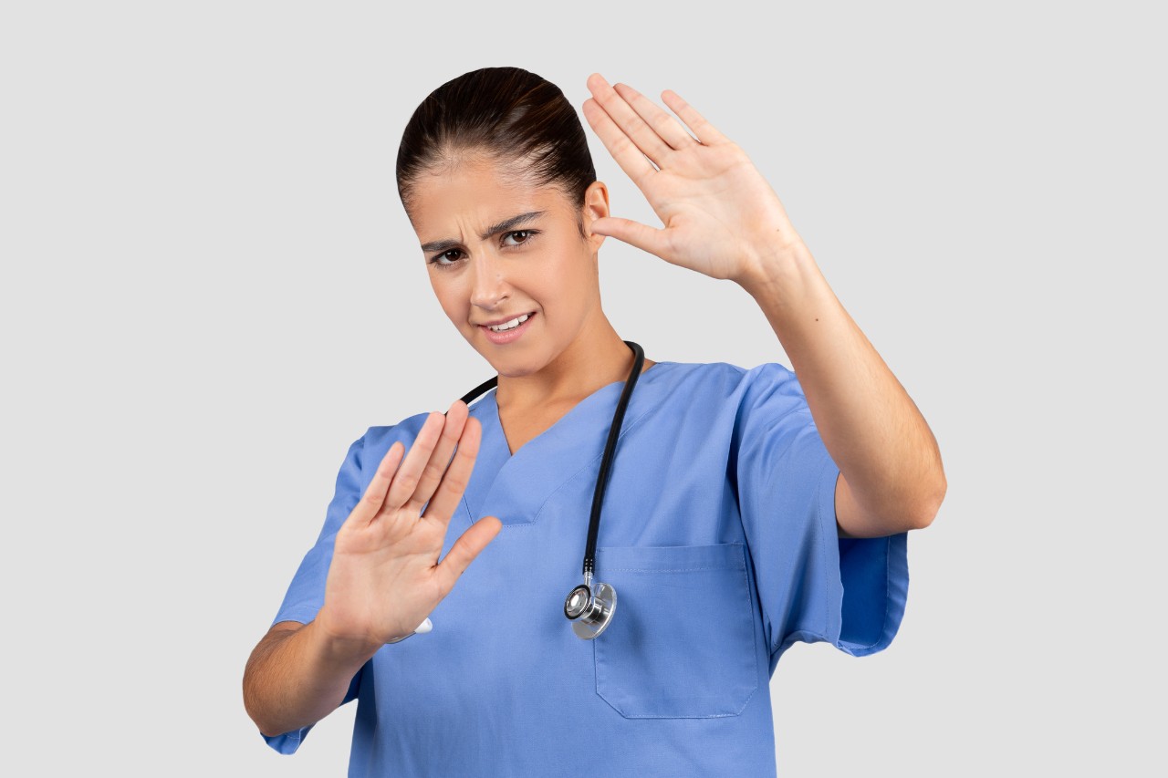 image of a nurse gesturing for someone to stop