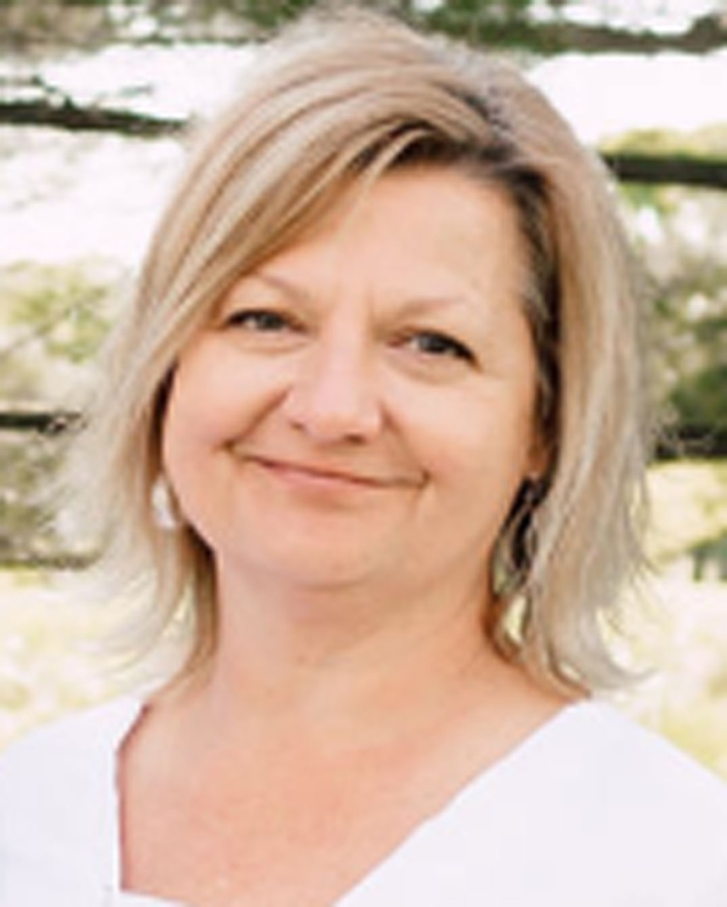 photo of Lori Foote outside and smiling on a sunny day