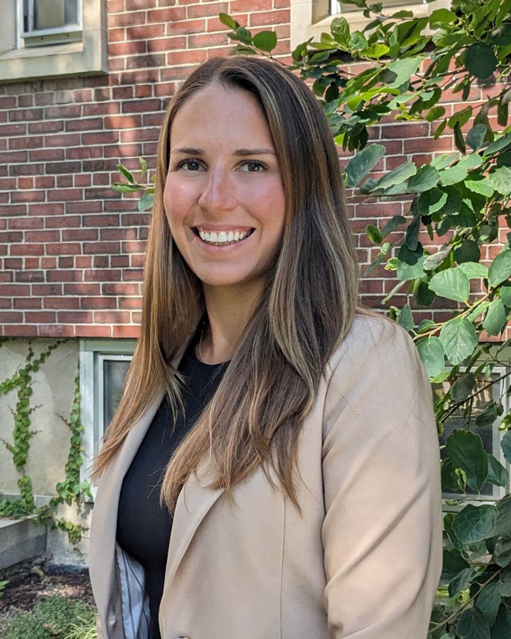 headshot of Kierston Giunco who is outside beside a treee and smiling
