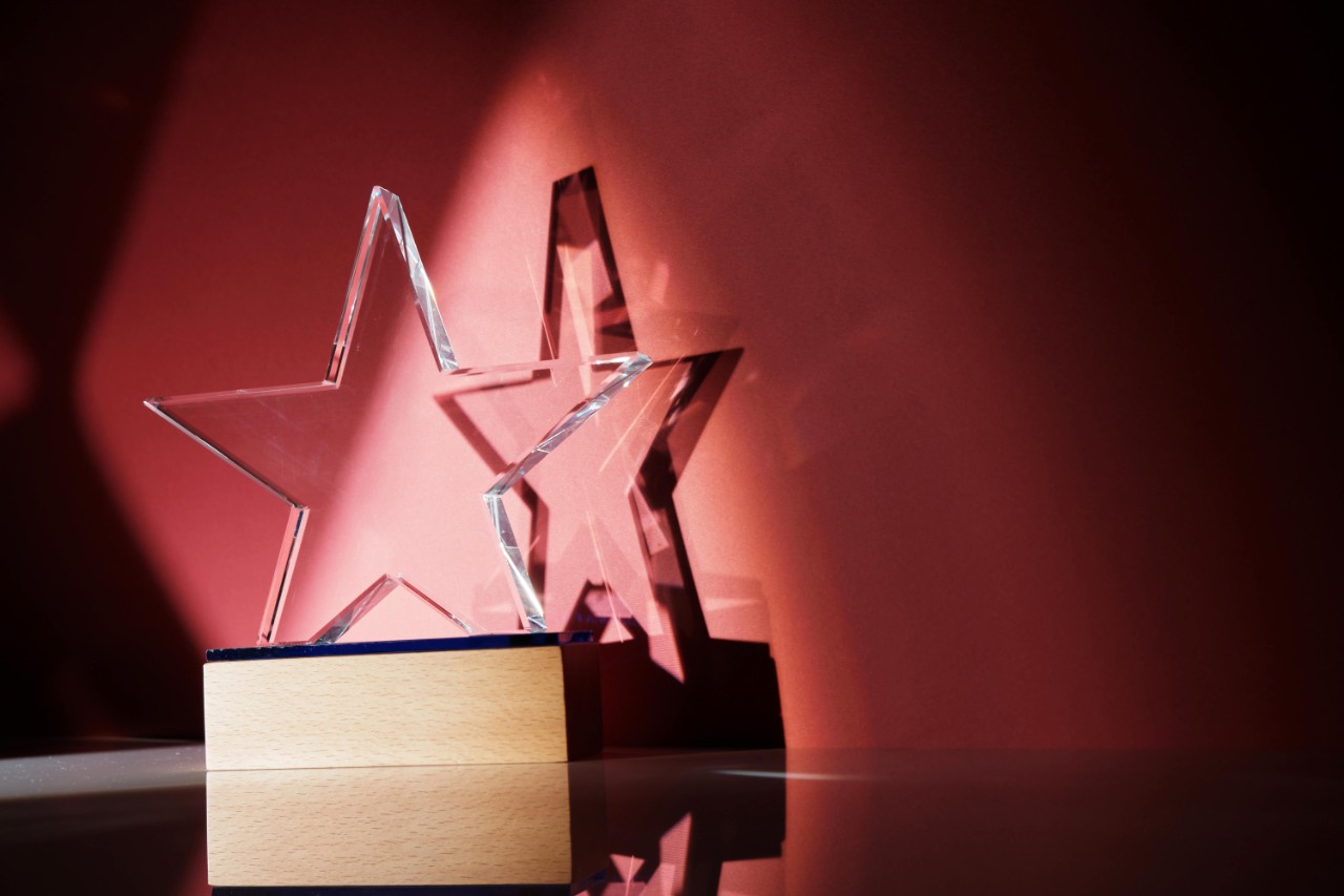 acrylic star trophy against red wall