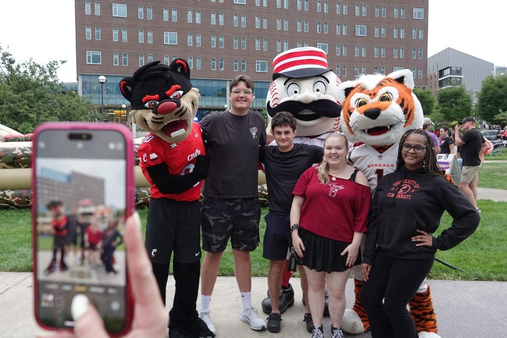 The Bearcat poses for photos with Mr. Redlegs and Who Dey.