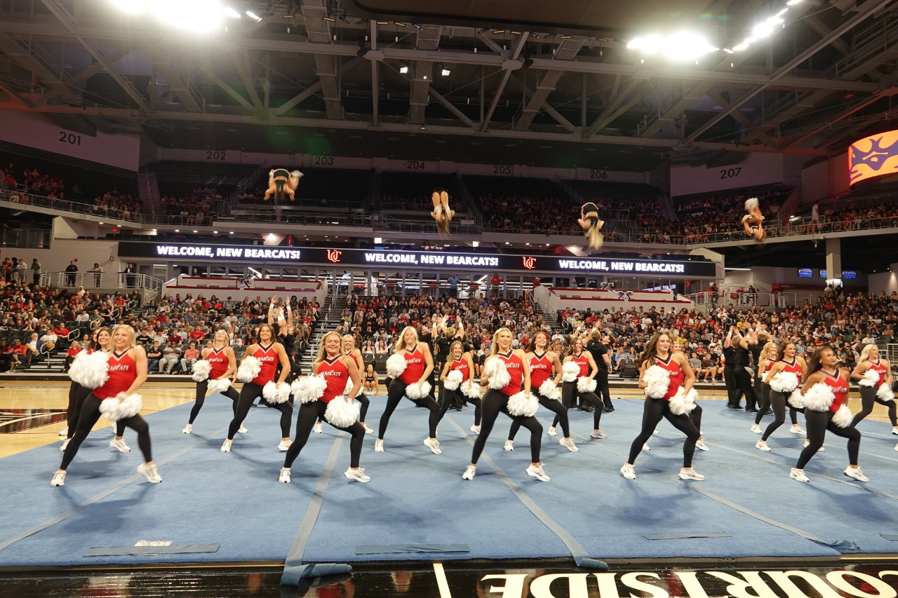UC students perform on the floor of Fifth Third Arena.