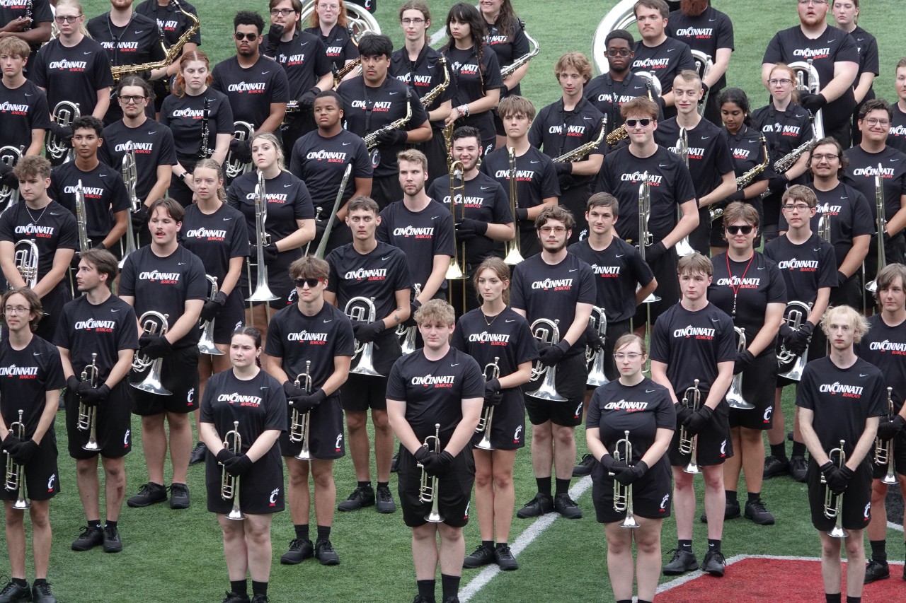 The UC Marching Band performs on the field at Nippert Stadium.