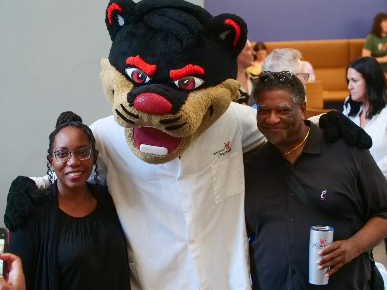 The Bearcat poses with invited guests. 