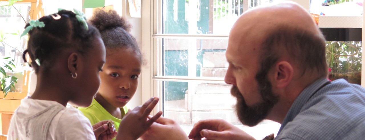 Arlitt teacher working with two students