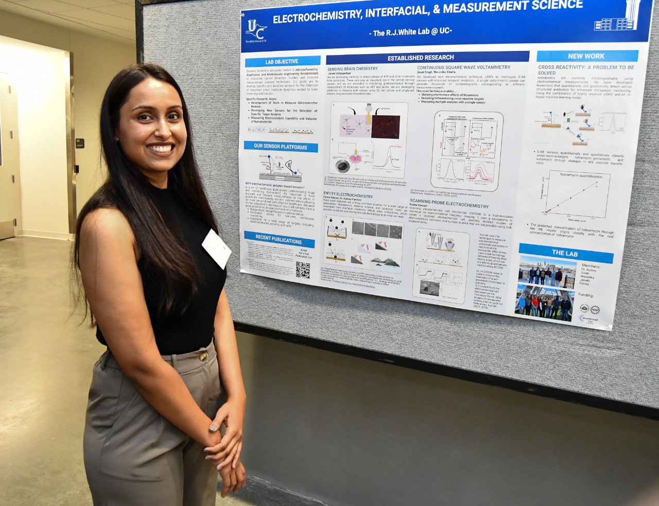 Swati Singh stands in front of her research poster.