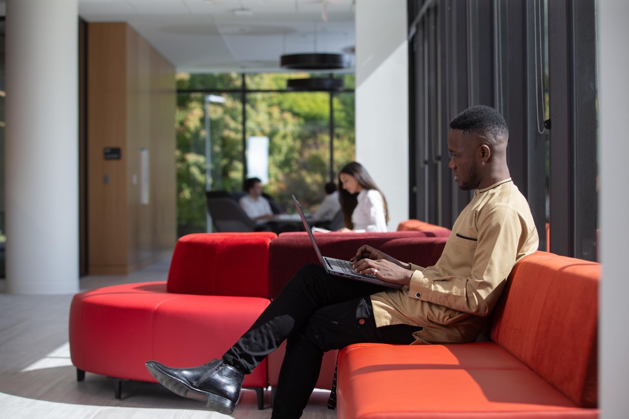 UC students sit with their laptops learning about time management