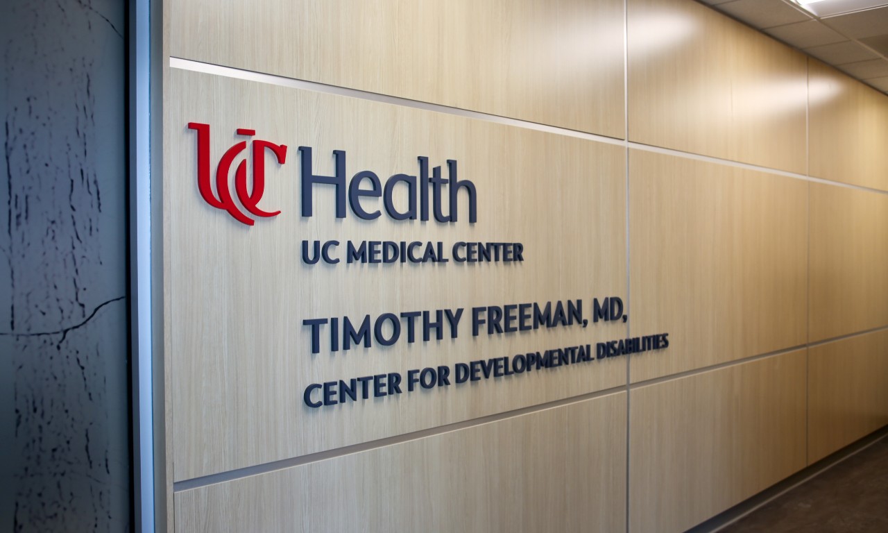 Hallway sign stating the name of the new UC Health/UC Medical Center's Timothy Freeman, MD, Center for Developmental Disabilities.
