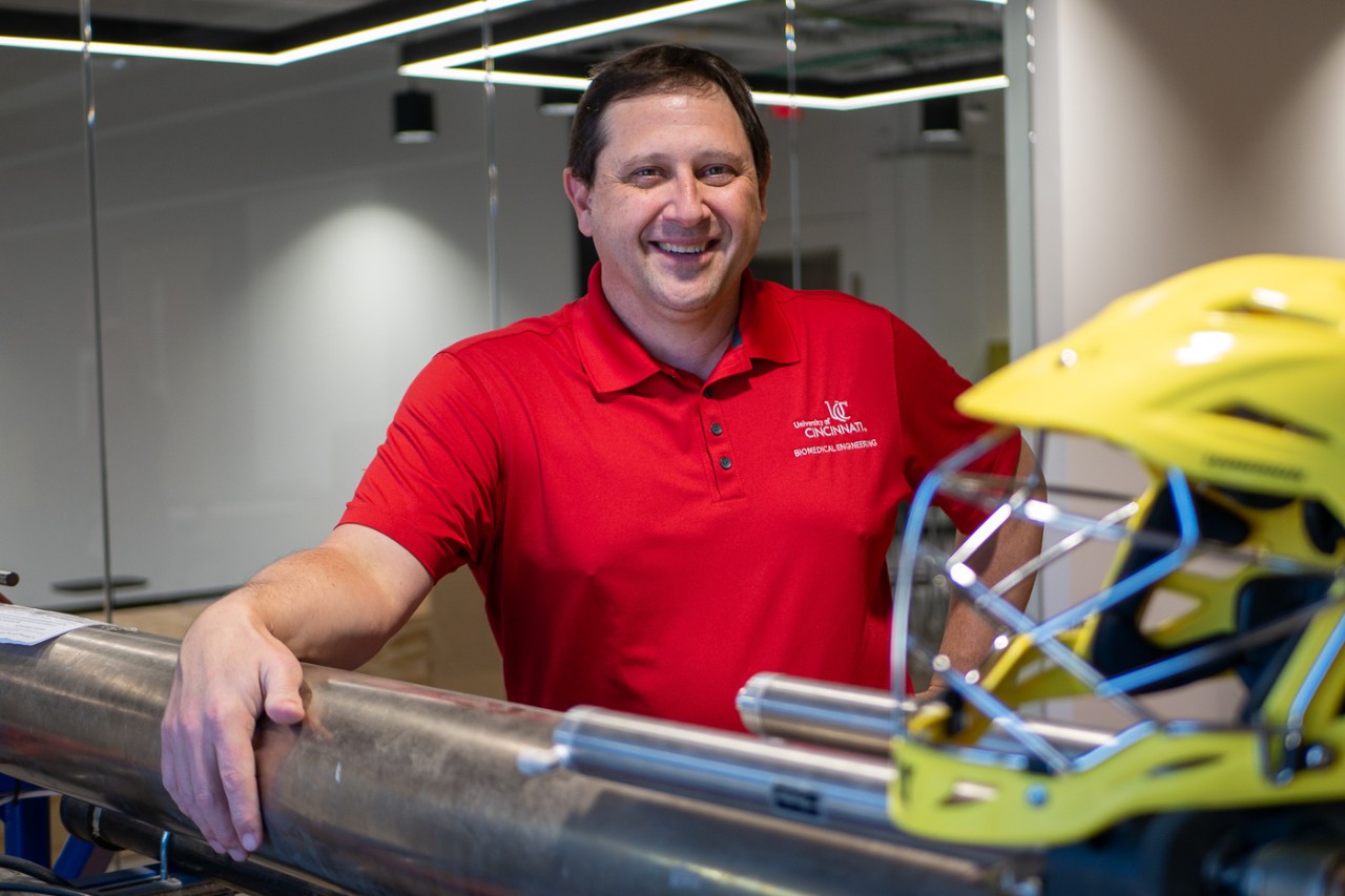 Portrait of Tom Talavage behind a helmet.