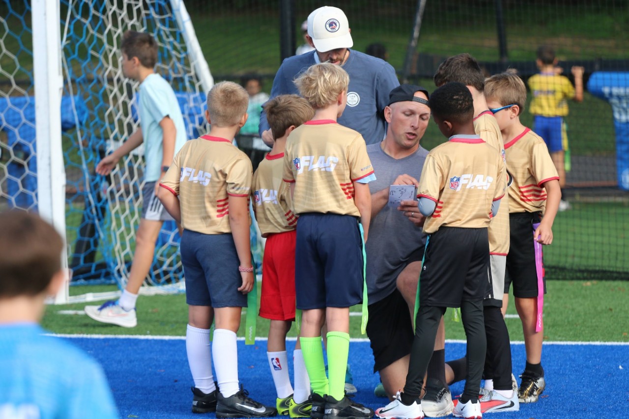 Baldwin coaching his son's flag football team.