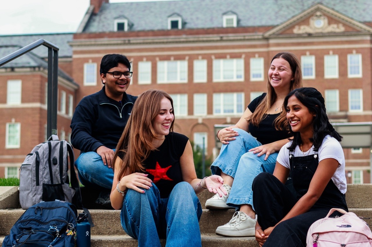 UC Bearcat students conversing on campus stairs