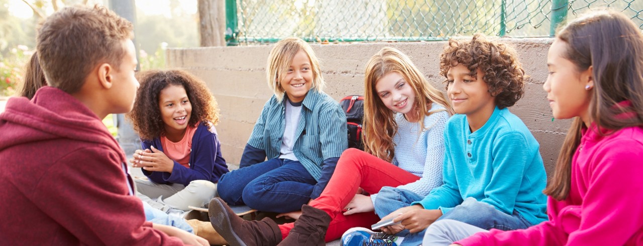 young students chatting on the floor