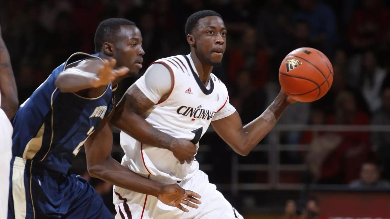 Cashmere Wright passes the ball in a basketball game for the University of Cincinnati Bearcats